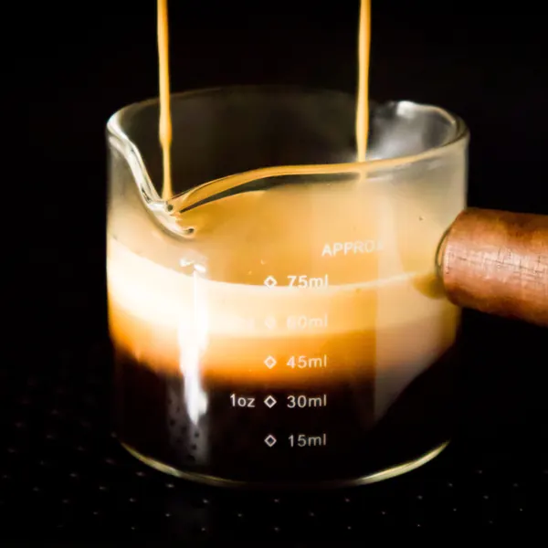 Espresso extracting into a glass