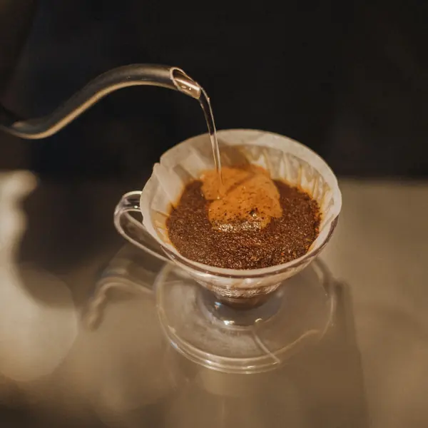 Hot water blooming over fresh grounds in a pour-over